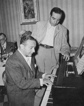 Arthur Freed (at the piano) with director Vincente Minnelli